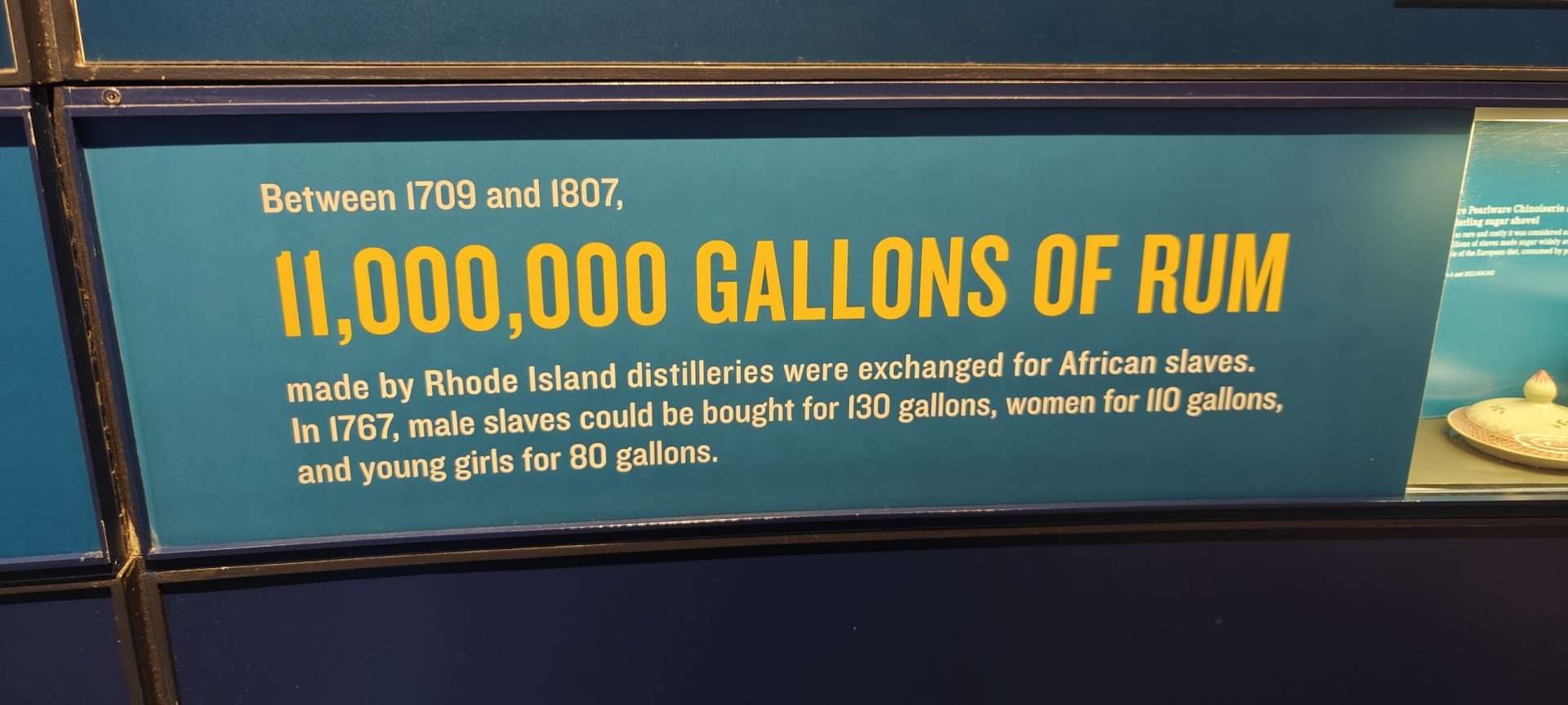 History of rum production and slave trade in Rhode Island, highlighting 11 million gallons of rum exchanged for African slaves between 1709 and 1807.