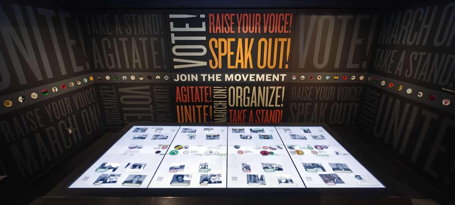 An interactive exhibit with Raise Your Voice and Speak Out slogans encouraging activism, at the National Civil Rights Museum in Memphis.